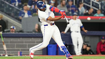 Sep 27, 2024; Toronto, Ontario, CAN; Toronto Blue Jays first baseman Vladimir Guerrero Jr. (27) hits a single against the Miami Marlins during the eighth inning at Rogers Centre. Mandatory Credit: Nick Turchiaro-Imagn Images