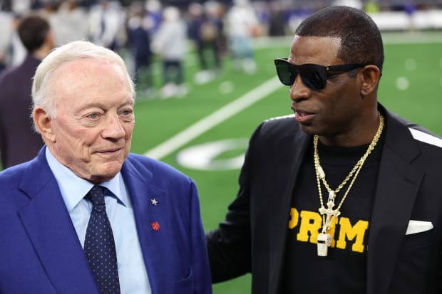 Colorado Buffaloes head coach Deion Sanders (right) talks with Dallas Cowboys owner Jerry Jones 