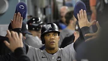 Oct 26, 2024; Los Angeles, California, USA; New York Yankees outfielder Juan Soto (22) celebrates in the dugout after scoring on an RBI single by designated hitter Giancarlo Stanton (not pictured) in the ninth inning against the Los Angeles Dodgers during game two of the 2024 MLB World Series at Dodger Stadium. Mandatory Credit: Jayne Kamin-Oncea-Imagn Images