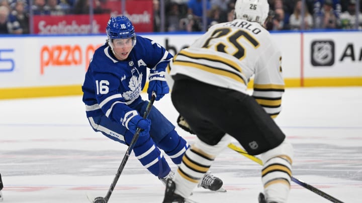 May 2, 2024; Toronto, Ontario, CAN;   Toronto Maple Leafs forward Mitch Marner (16) plays the puck past Boston Bruins defenseman Brandon Carlo (25) in the first period in game six of the first round of the 2024 Stanley Cup Playoffs at Scotiabank Arena. Mandatory Credit: Dan Hamilton-USA TODAY Sports