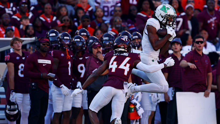 Sep 7, 2024; Blacksburg, Virginia, USA; Marshall Thundering Herd wide receiver Christian Fitzpatrick (16) makes a catch against Virginia Tech Hokies cornerback Dorian Strong (44) during the first quarter at Lane Stadium. Mandatory Credit: Peter Casey-Imagn Images