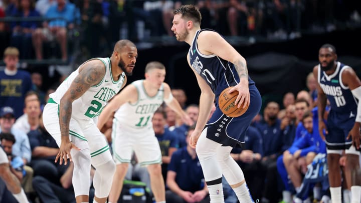 Jun 12, 2024; Dallas, Texas, USA; Dallas Mavericks guard Luka Doncic (77) dribbles the ball against Boston Celtics forward Xavier Tillman (26) during the second quarter during game three of the 2024 NBA Finals at American Airlines Center. Mandatory Credit: Kevin Jairaj-USA TODAY Sports