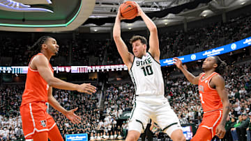 Nov 16, 2024; East Lansing, Michigan, USA;  Michigan State Spartans center Szymon Zapala (10) keeps a rebound away from Bowling Green Falcons forward Sam Towns (14) and guard Javontae Campbell (2) during the second half at Jack Breslin Student Events Center. Mandatory Credit: Dale Young-Imagn Images