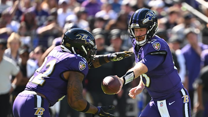 Oct 5, 2025; Baltimore, Maryland, USA; Baltimore Ravens quarterback Cooper Rush (15) hands the ball off to running back Derrick Henry (22) during the first quarter against the Houston Texans at M&T Bank Stadium. Mandatory Credit: Rafael Suanes-Imagn Images