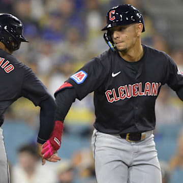 Sep 6, 2024; Los Angeles, California, USA; Cleveland Guardians second baseman Andres Gimenez (0) is congratulated by shortstop Brayan Rocchio (4) after hitting a two-run home run in the sixth inning against the Los Angeles Dodgers at Dodger Stadium. Mandatory Credit: Jayne Kamin-Oncea-Imagn Images