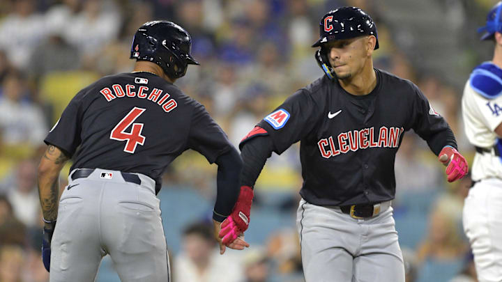 Sep 6, 2024; Los Angeles, California, USA; Cleveland Guardians second baseman Andres Gimenez (0) is congratulated by shortstop Brayan Rocchio (4) after hitting a two-run home run in the sixth inning against the Los Angeles Dodgers at Dodger Stadium. Mandatory Credit: Jayne Kamin-Oncea-Imagn Images