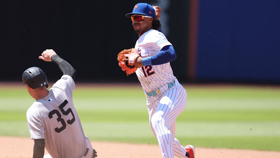 New York Mets shortstop Francisco Lindor attempts to turn a double play after forcing out Yankees left fielder Cody Bellinger.