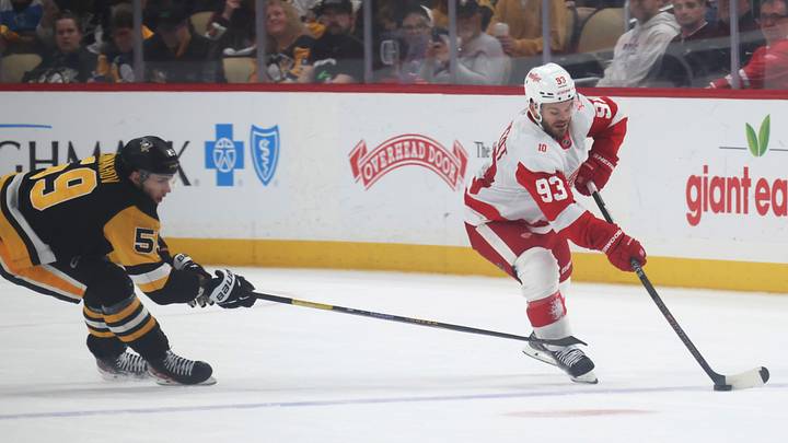 Mar 31, 2026; Pittsburgh, Pennsylvania, USA;  Detroit Red Wings right wing Alex DeBrincat (93) moves the puck against Pittsburgh Penguins right wing Egor Chinakhov (59) during the second period at PPG Paints Arena. Mandatory Credit: Charles LeClaire-Imagn Images