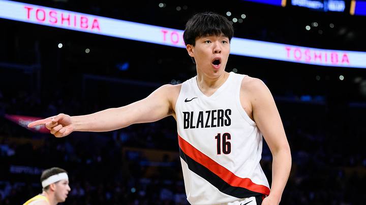 Oct 27, 2025; Los Angeles, California, USA; Portland Trail Blazers center Yang Hansen (16) reacts during the first half against the Los Angeles Lakers at Crypto.com Arena. Mandatory Credit: William Liang-Imagn Images