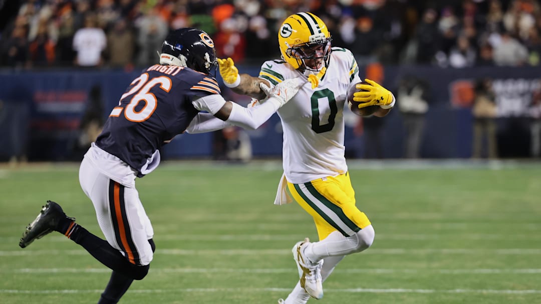 Dec 20, 2025; Chicago, Illinois, USA; Green Bay Packers wide receiver Matthew Golden (0) runs with the ball against Chicago Bears cornerback Nahshon Wright (26) during the first quarter at Soldier Field. Mandatory Credit: Mike Dinovo-Imagn Images