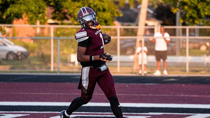 Harper Woods wide receiver Dakota Guerrant runs for a touchdown against Birmingham Groves during the first half at Harper Woods High School in Harper Woods on Friday, Sept. 12, 2025.