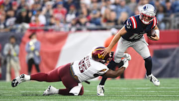 Aug 8, 2025; Foxborough, Massachusetts, USA; Washington Commanders safety Dominique Hampton (45) tackles New England Patriots quarterback Drake Maye (10) during the first half at Gillette Stadium. Mandatory Credit: Brian Fluharty-Imagn Images