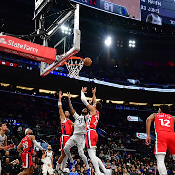 Apr 4, 2025; Inglewood, California, USA; Dallas Mavericks forward Naji Marshall (13) plays for the rebound against Los Angeles Clippers guard Trentyn Flowers (9) and forward Patrick Baldwin Jr. (23) during the second half at Intuit Dome. Mandatory Credit: Gary A. Vasquez-Imagn Images