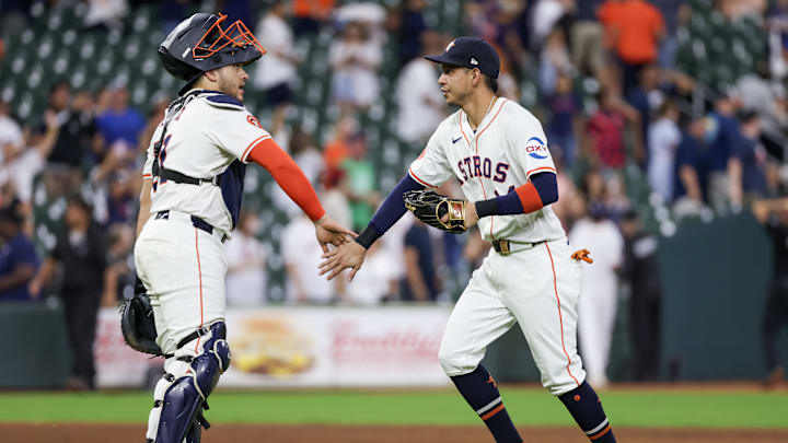 Aug 29, 2024; Houston, Texas, USA;  Houston Astros catcher Yainer Diaz (21) and left fielder Mauricio Dubon (14) celebrate the win after defeating the Kansas City Royals at Minute Maid Park. Mandatory Credit: Thomas Shea-Imagn Images