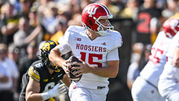 Sep 27, 2025; Iowa City, Iowa, USA; Indiana Hoosiers quarterback Fernando Mendoza (15) rolls out to throw a pass against the Iowa Hawkeyes during the first quarter at Kinnick Stadium. Mandatory Credit: Jeffrey Becker-Imagn Images