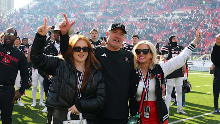 Nov 30, 2024; Lubbock, Texas, USA; Texas Tech Red Raiders head coach Joey McGuire celebrates with wife Debbie after a game against the West Virginia Mountaineers at Jones AT&T Stadium and Cody Campbell Field. Mandatory Credit: Michael C. Johnson-Imagn Images