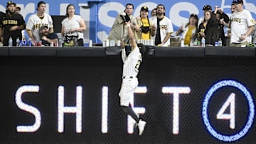 Jul 8, 2025; San Diego, California, USA; San Diego Padres right fielder Fernando Tatis Jr. (23) makes a catch at the wall on a hit by Arizona Diamondbacks first baseman Josh Naylor (22) during the eighth inning at Petco Park. Mandatory Credit: Denis Poroy-Imagn Images