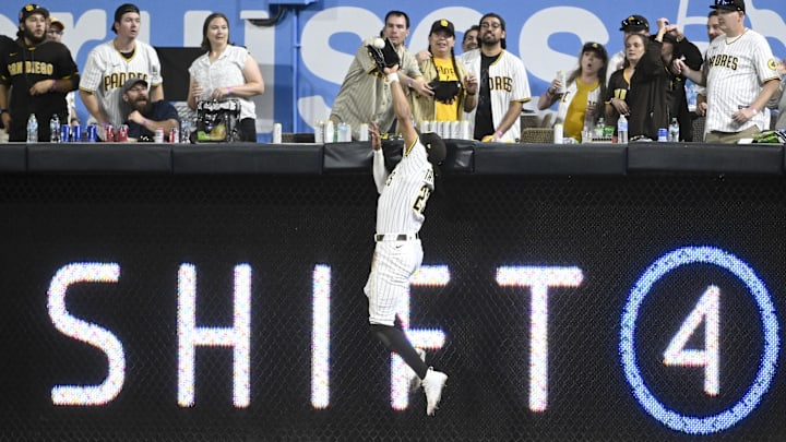 Jul 8, 2025; San Diego, California, USA; San Diego Padres right fielder Fernando Tatis Jr. (23) makes a catch at the wall on a hit by Arizona Diamondbacks first baseman Josh Naylor (22) during the eighth inning at Petco Park. Mandatory Credit: Denis Poroy-Imagn Images