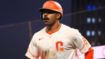 May 14, 2024; San Francisco, California, USA; San Francisco Giants first baseman LaMonte Wade Jr. (31) returns to the dugout after scoring a run against the Los Angeles Dodgers during the sixth inning at Oracle Park. Mandatory Credit: Kelley L Cox-USA TODAY Sports