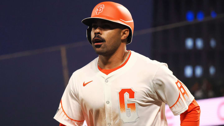 May 14, 2024; San Francisco, California, USA; San Francisco Giants first baseman LaMonte Wade Jr. (31) returns to the dugout after scoring a run against the Los Angeles Dodgers during the sixth inning at Oracle Park. Mandatory Credit: Kelley L Cox-USA TODAY Sports