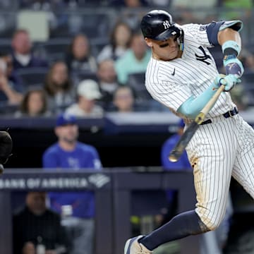 Sep 9, 2024; Bronx, New York, USA; New York Yankees designated hitter Aaron Judge (99) follows through on an RBI single against the Kansas City Royals during the seventh inning at Yankee Stadium. Mandatory Credit: Brad Penner-Imagn Images