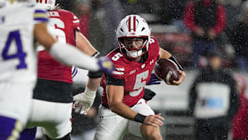 Nov 8, 2025; Madison, Wisconsin, USA;  Wisconsin Badgers quarterback Carter Smith (5) rushes with the football during the third quarter against the Washington Huskies at Camp Randall Stadium. Mandatory Credit: Jeff Hanisch-Imagn Images