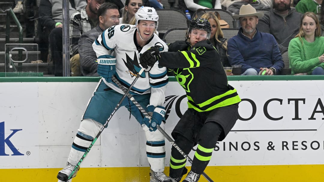 Dec 31, 2022; Dallas, Texas, USA; Dallas Stars center Ty Dellandrea (10) checks San Jose Sharks center Logan Couture (39) during the third period at the American Airlines Center. Mandatory Credit: Jerome Miron-USA TODAY Sports