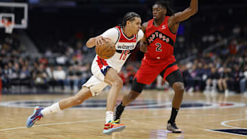 Oct 11, 2024; Washington, District of Columbia, USA; Washington Wizards forward Kyshawn George (18) drives to the basket as Toronto Raptors forward Jonathan Mogbo (2) defends in the second quarter at Capital One Arena. Mandatory Credit: Geoff Burke-Imagn Images