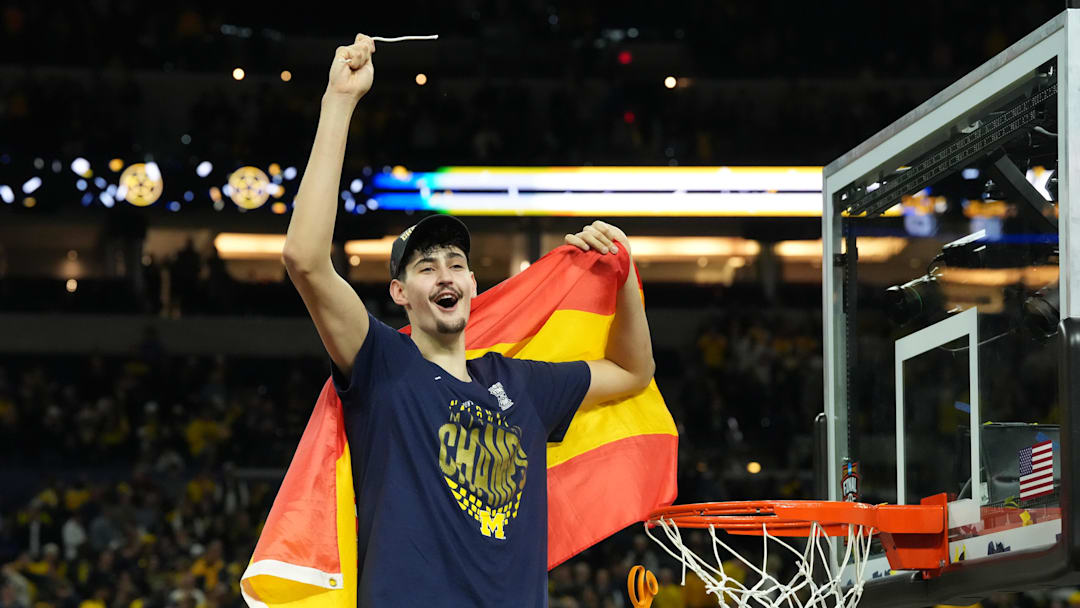 Apr 6, 2026; Indianapolis, IN, USA; Michigan Wolverines center Aday Mara (15) celebrates after cutting down a piece of the net after defeating the Connecticut Huskies in the national championship of the Final Four of the men's 2026 NCAA Tournament at Lucas Oil Stadium. Mandatory Credit: Robert Deutsch-Imagn Images