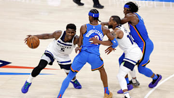 Minnesota Timberwolves star Anthony Edwards passes Oklahoma City Thunder star Shai Gilgeous-Alexander during the NBA Playoffs