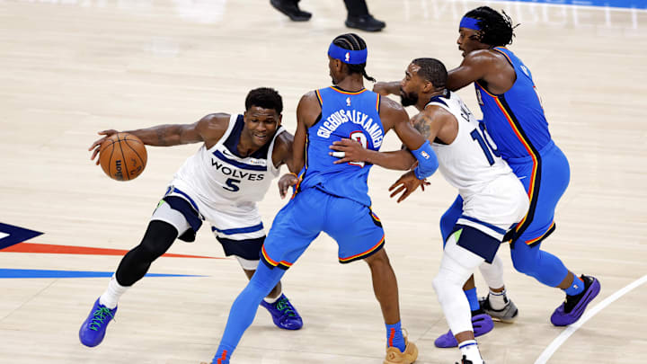Minnesota Timberwolves star Anthony Edwards passes Oklahoma City Thunder star Shai Gilgeous-Alexander during the NBA Playoffs