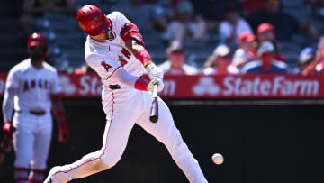 Aug 4, 2024; Anaheim, California, USA; Los Angeles Angels designated hitter Logan O'Hoppe (14) singles against the New York Mets during the eighth inning at Angel Stadium. Mandatory Credit: Jonathan Hui-USA TODAY Sports