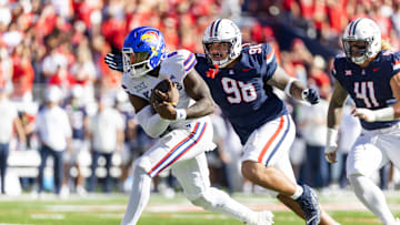 Nov 8, 2025; Tucson, Arizona, USA; Kansas Jayhawks quarterback Jalon Daniels (6) against Arizona Wildcats defensive lineman Tiaoalii Savea (98) at Arizona Stadium. Mandatory Credit: Mark J. Rebilas-Imagn Images