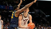Mar 11, 2025; Charlotte, NC, USA; Virginia Tech Hokies center Patrick Wessler (5) with the ball as California Golden Bears center Mady Sissoko (12) defends in the first half at Spectrum Center. Mandatory Credit: Bob Donnan-Imagn Images