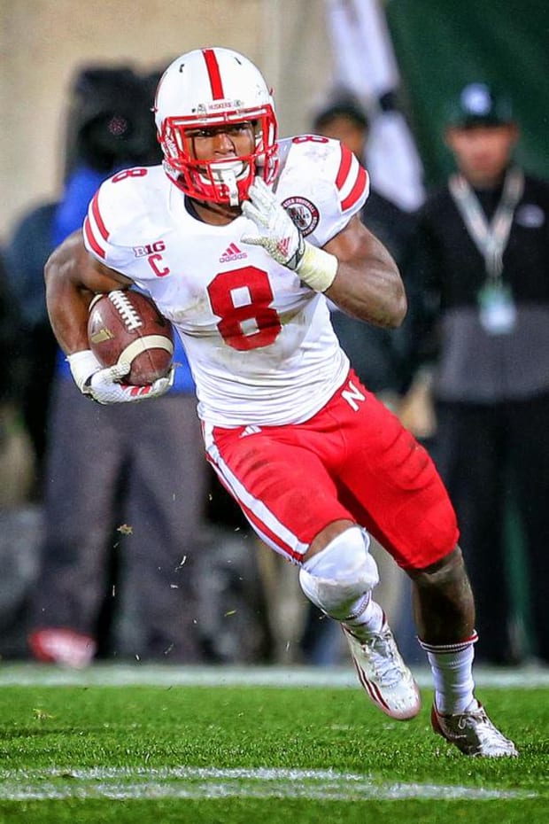Nebraska Cornhuskers running back Ameer Abdullah runs with the ball against the Michigan State Spartans.