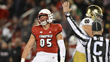 Oct 7, 2023; Louisville, Kentucky, USA;  Louisville Cardinals defensive lineman Mason Reiger (95) reacts after sacking Notre Dame Fighting Irish quarterback Sam Hartman (10) during the first half at L&N Federal Credit Union Stadium. Mandatory Credit: Jamie Rhodes-Imagn Images