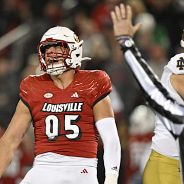 Oct 7, 2023; Louisville, Kentucky, USA;  Louisville Cardinals defensive lineman Mason Reiger (95) reacts after sacking Notre Dame Fighting Irish quarterback Sam Hartman (10) during the first half at L&N Federal Credit Union Stadium.