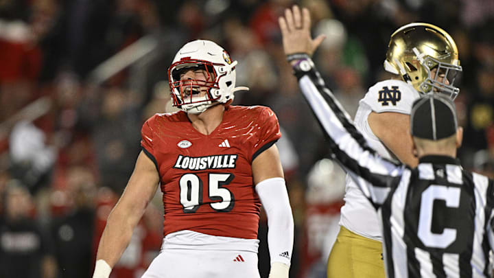 Oct 7, 2023; Louisville, Kentucky, USA;  Louisville Cardinals defensive lineman Mason Reiger (95) reacts after sacking Notre Dame Fighting Irish quarterback Sam Hartman (10) during the first half at L&N Federal Credit Union Stadium. Mandatory Credit: Jamie Rhodes-Imagn Images