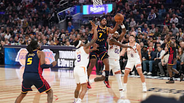 Jan 31, 2025; San Francisco, California, USA; Golden State Warriors guard Buddy Hield (7) makes a layup over Phoenix Suns guard Bradley Beal (3) in the second quarter at the Chase Center. Mandatory Credit: Cary Edmondson-Imagn Images