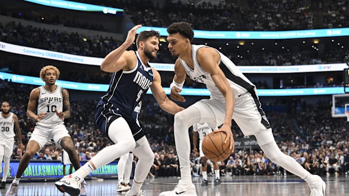 Oct 24, 2024; Dallas, Texas, USA; San Antonio Spurs center Victor Wembanyama (1) looks to move the ball past Dallas Mavericks forward Maxi Kleber (42) during the second quarter at the American Airlines Center. Mandatory Credit: Jerome Miron-Imagn Images