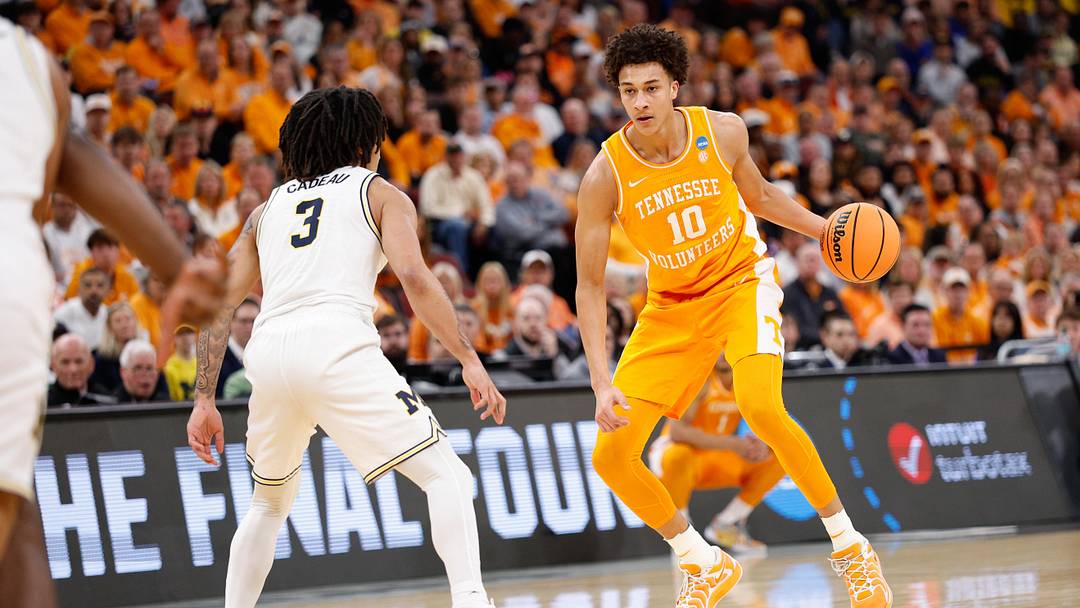 Mar 29, 2026; Chicago, IL, USA; Tennessee Volunteers forward Nate Ament (10) moves the ball while defended by Michigan Wolverines guard Elliot Cadeau (3) in the first half during an Elite Eight game of the Midwest Regional of the men's 2026 NCAA Tournament at United Center. Mandatory Credit: Kamil Krzaczynski-Imagn Images Mar 29, 2026; Chicago, IL, USA; Tennessee Volunteers forward Nate Ament (10) moves the ball while defended by Michigan Wolverines guard Elliot Cadeau (3) in the first half during an Elite Eight game of the Midwest Regional of the men's 2026 NCAA Tournament at United Center. Mandatory Credit: Kamil Krzaczynski-Imagn Images