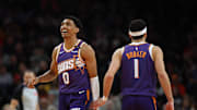 Jan 9, 2025; Phoenix, Arizona, USA; Phoenix Suns forward Ryan Dunn (0) and guard Devin Booker (1) against the Atlanta Hawks in the second half at Footprint Center. Mandatory Credit: Mark J. Rebilas-Imagn Images