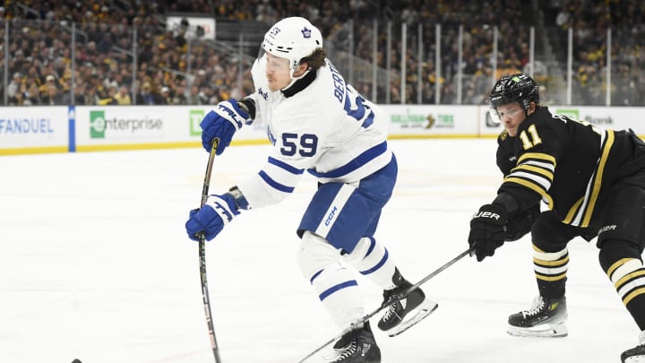 May 4, 2024; Boston, Massachusetts, USA; Toronto Maple Leafs left wing Tyler Bertuzzi (59) shoots the puck while Boston Bruins center Trent Frederic (11) defends during the second period in game seven of the first round of the 2024 Stanley Cup Playoffs at TD Garden. Mandatory Credit: Bob DeChiara-USA TODAY Sports