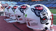 Sep 7, 2024; Charlotte, North Carolina, USA; North Carolina State Wolfpack helmets during pregame activity for the Dukes Mayo Classic against the Tennessee Volunteers at Bank of America Stadium. Mandatory Credit: Jim Dedmon-Imagn Images