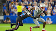 Sep 13, 2024; Kansas City, Kansas, USA; UNLV Rebels wide receiver Ricky White III (11) runs with the ball against Kansas Jayhawks cornerback Cobee Bryant (2) during the second half at Children's Mercy Park. Mandatory Credit: Jay Biggerstaff-Imagn Images