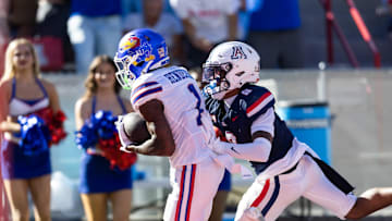 Nov 8, 2025; Tucson, Arizona, USA; Kansas Jayhawks wide receiver Emmanuel Henderson Jr. (1) runs for a touchdown against Arizona Wildcats defensive back Jay'Vion Cole (8) at Arizona Stadium. Mandatory Credit: Mark J. Rebilas-Imagn Images