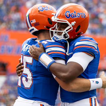 Florida Gators quarterbacks Graham Mertz (15) and DJ Lagway (2) embrace before the game against the Texas A&M Aggies