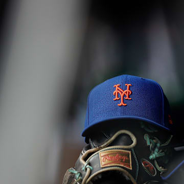 Aug 8, 2024; Denver, Colorado, USA; A New York Mets hat and glove in the dugout in the second inning against the Colorado Rockies at Coors Field. Mandatory Credit: Isaiah J. Downing-Imagn Images