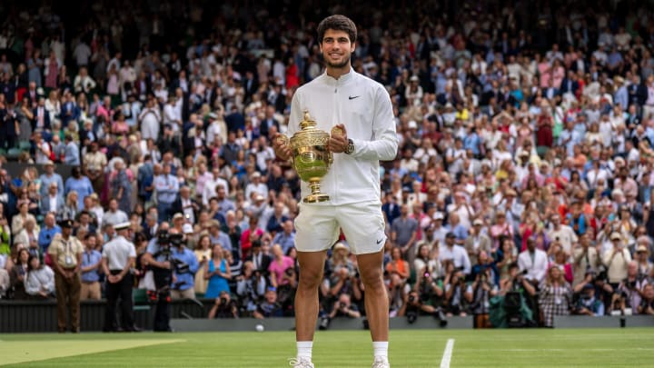 Jul 16, 2023; London, United Kingdom; Carlos Alcaraz (ESP) poses with the trophy after winning  the men   s singles final against Novak Djokovic (SRB) on day 14 at  the All England Lawn Tennis and Croquet Club. Mandatory Credit: Susan Mullane-USA TODAY Sports