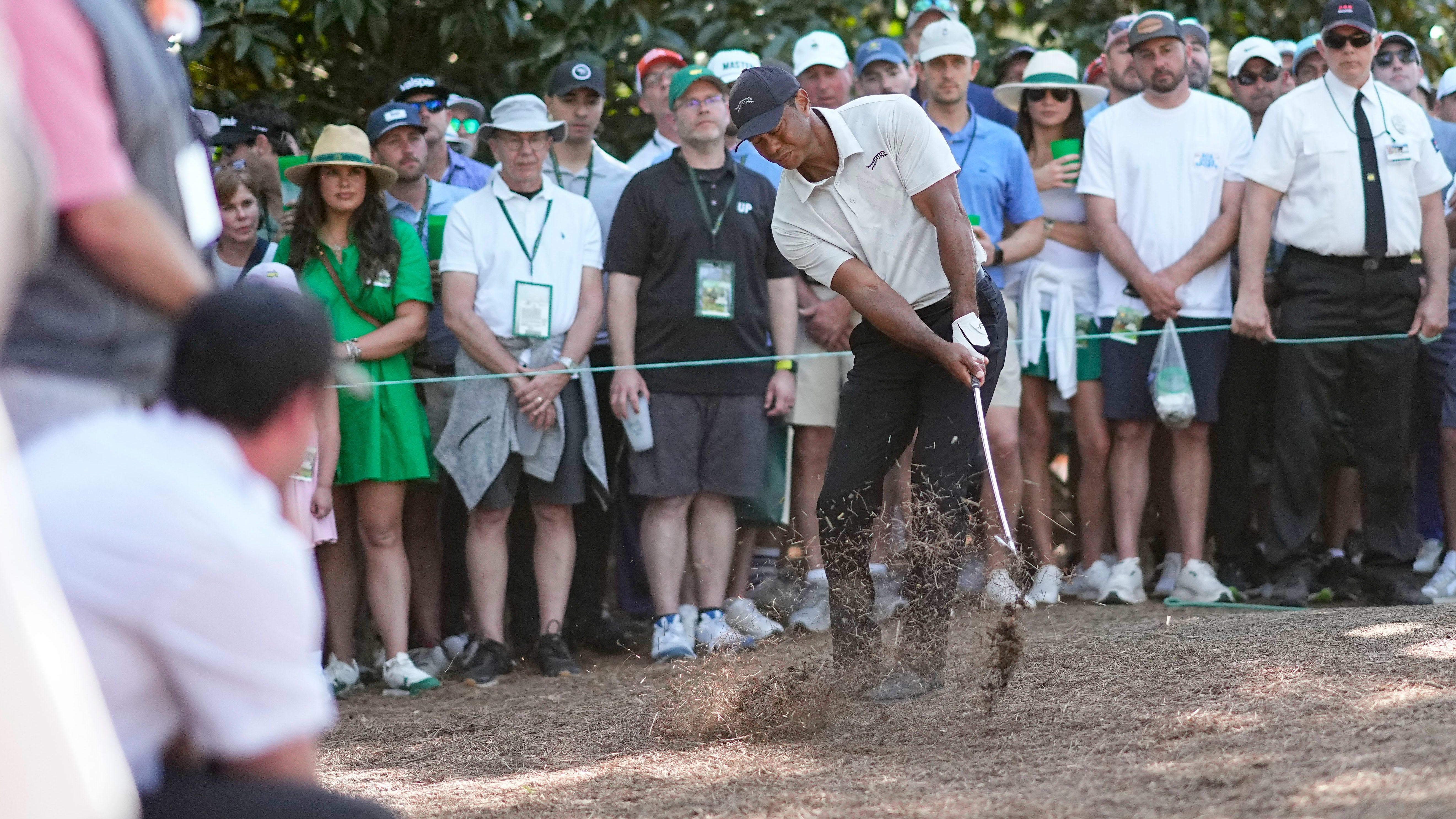 Tiger Woods hits from pine straw in third round of 2024 Masters.